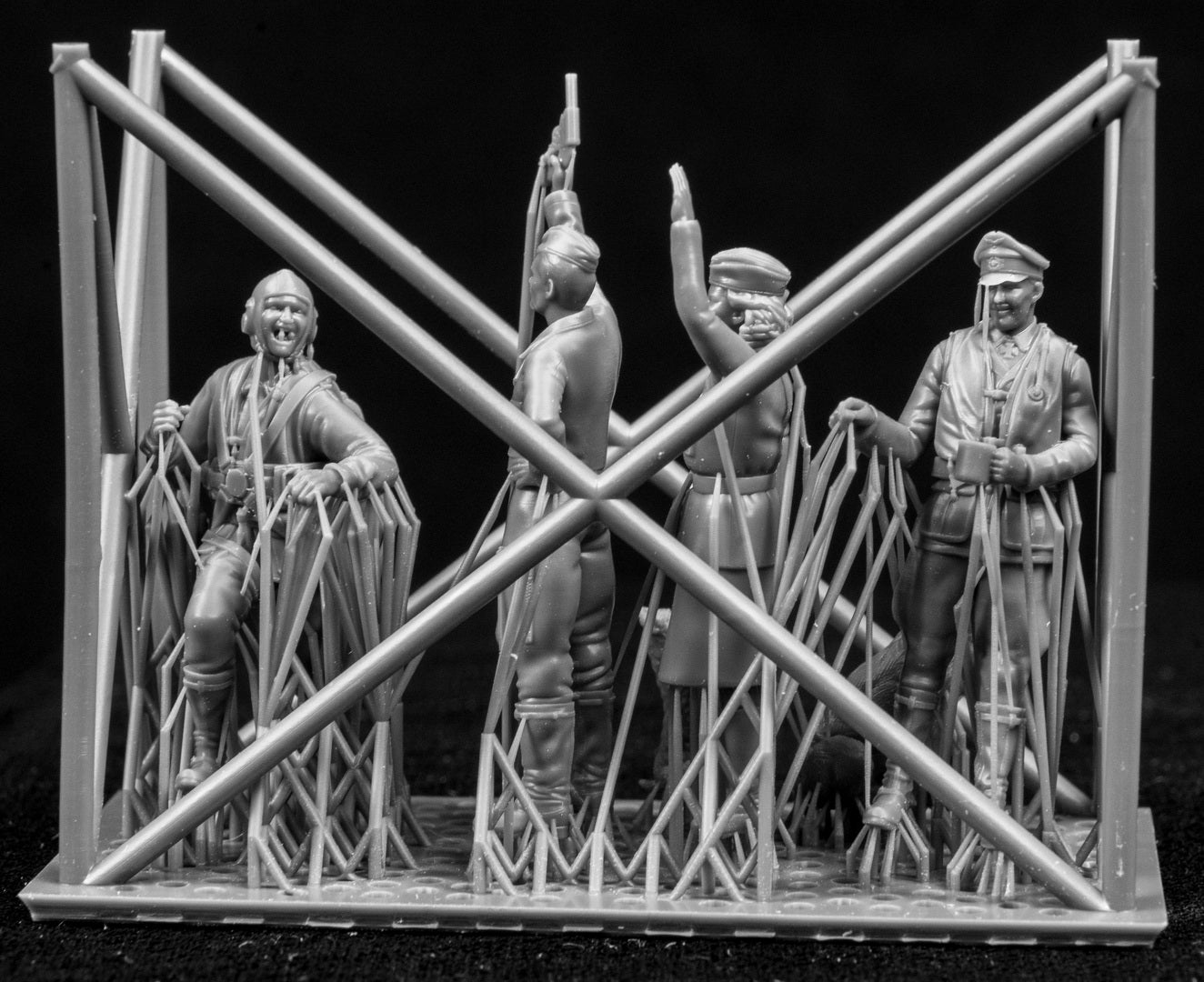 A collection of 3D printed figures on a frame with a black background.