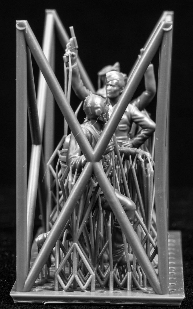 A collection of 3D printed figures on a frame with a black background.