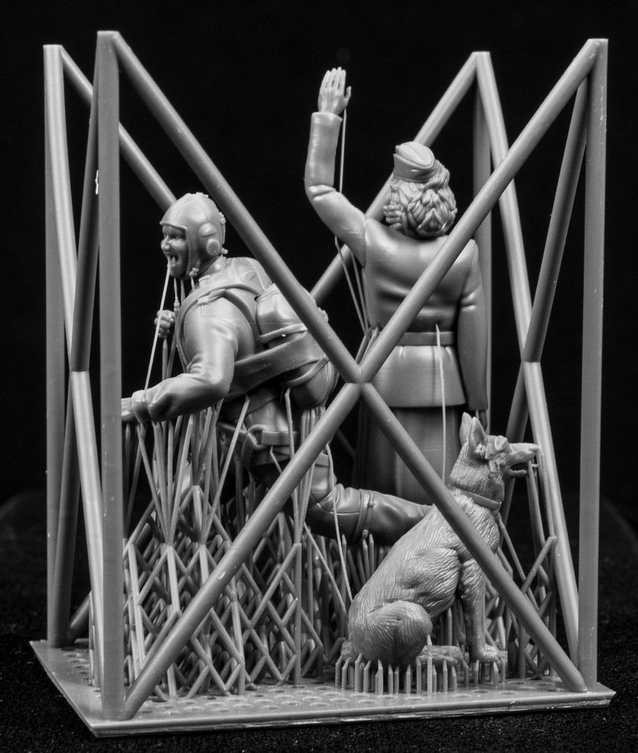 Two figurines in a cage-like structure on a black background