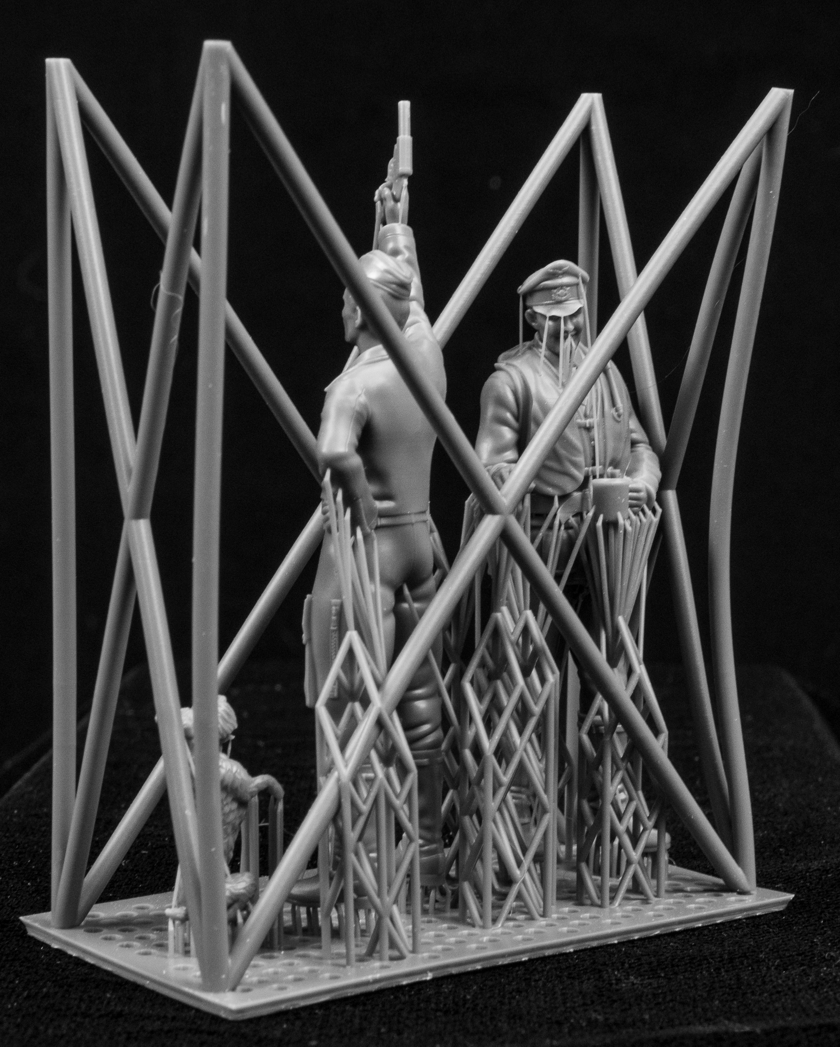 Model scene with figures and geometric structure on a black background