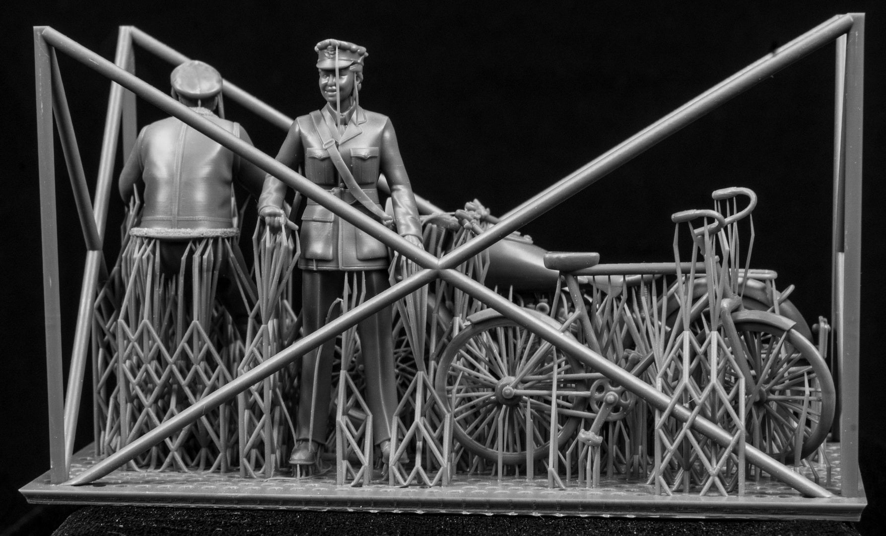 3D printed 1/32 RCAF & Commonwealth Cycling Pilot and WAAF. Two figures, a motorcycle and bicycle on a frame with a black background.