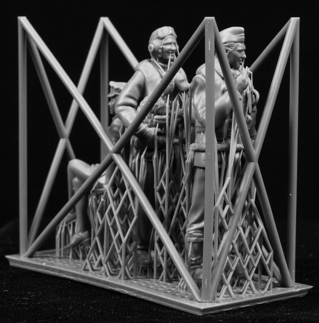 Model of a scene of figures of a 1/32 RCAF/Commonwealth Officer & WAAF behind a lattice structure on a black background