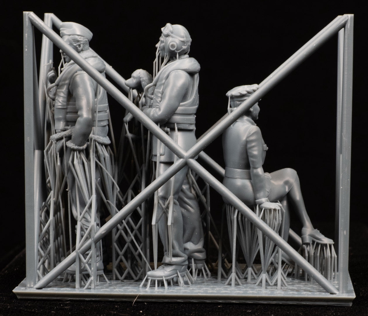 Model of a scene of figures of a 1/32 RCAF/Commonwealth Officer & WAAF behind a lattice structure on a black background