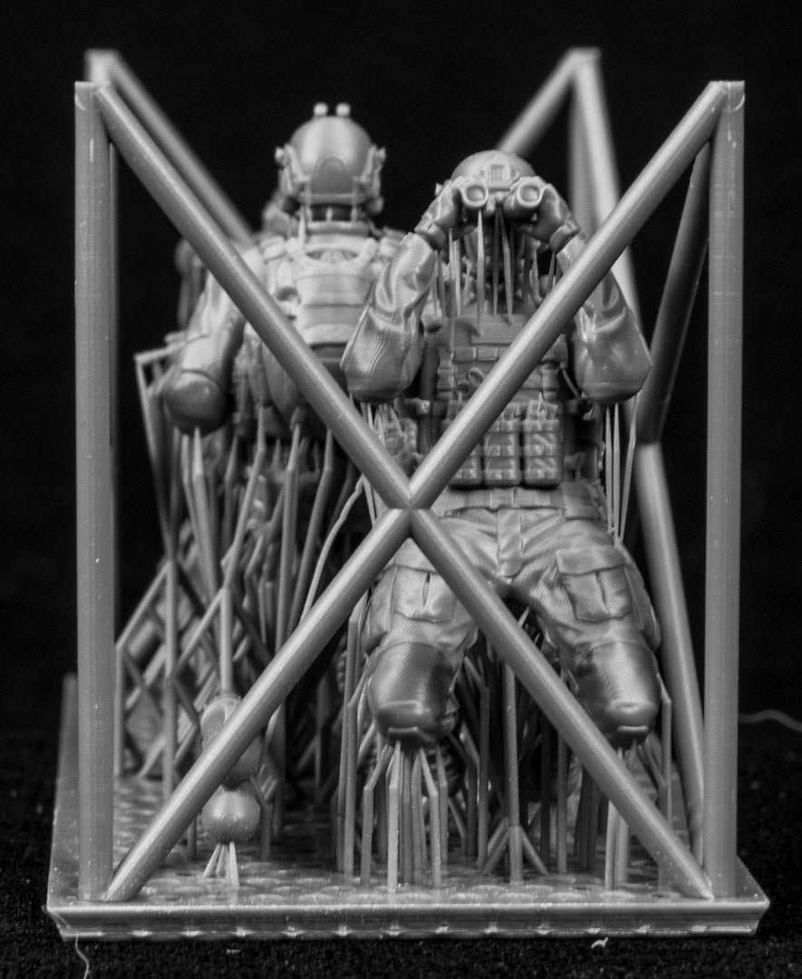 Metallic figurine of a warrior in armor inside a cage on a black background