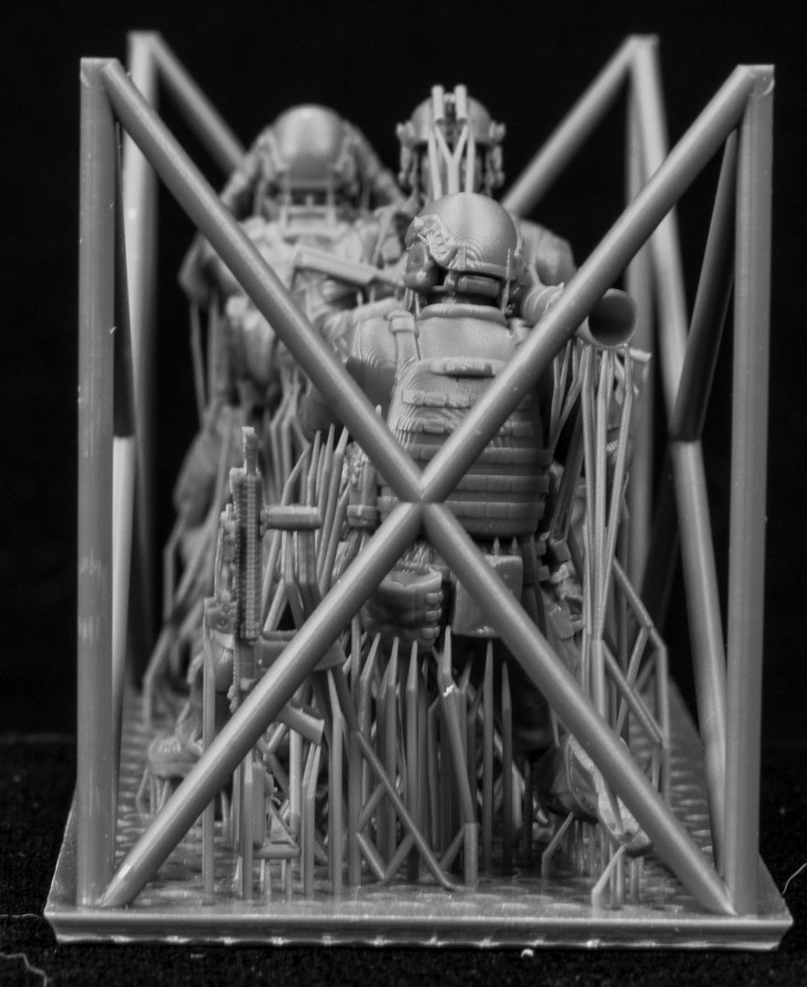 Detailed model of a mechanical figure in a cradle on a black background